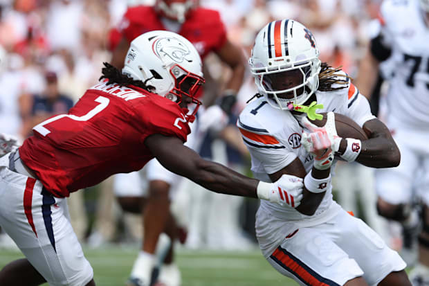 Auburn wide receiver Eric Singleton Jr. is tackled by South Alabama cornerback Jayvon Henderson.
