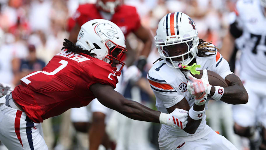 Auburn wide receiver Eric Singleton Jr. is tackled by South Alabama cornerback Jayvon Henderson.