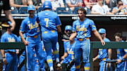 Jun 14, 2025; Omaha, Neb, USA;  UCLA Bruins third baseman Roman Martin (7) celebrates with teammates after scoring against the Murray State Racers during the fourth inning at Charles Schwab Field. Mandatory Credit: Steven Branscombe-Imagn Images
