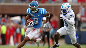 Sep 28, 2024; Oxford, Mississippi, USA; Mississippi Rebels wide receiver Tre Harris (9) runs after a catch as Kentucky Wildcats defensive back Jordan Lovett (25) pursues during the second half at Vaught-Hemingway Stadium. Mandatory Credit: Petre Thomas-Imagn Images