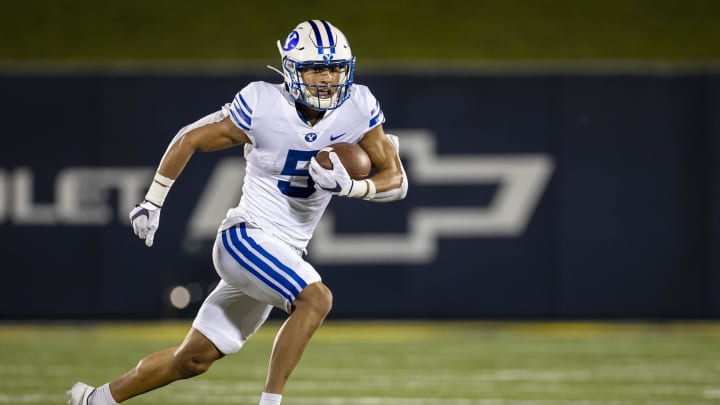 Sep 7, 2020; Annapolis, Maryland, USA; Brigham Young Cougars wide receiver Dax Milne (5) carries the ball against the Navy Midshipmen during the first half at Navy-Marine Corps Memorial Stadium. 