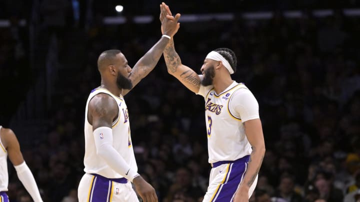 Mar 24, 2024; Los Angeles, California, USA; Los Angeles Lakers forward LeBron James (23) and center Anthony Davis (3) celebrate a play.