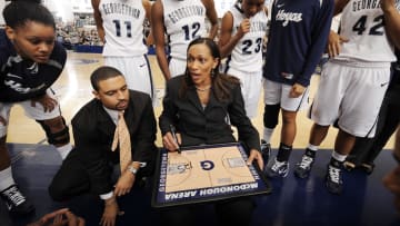 Nov 16, 2010; Washington, DC, USA; Georgetown Hoyas head coach Terri Williams-Flournoy (center) and assistant coach Cory McNeill (left) give out instructions during a time out against the Maryland Terrapins during the second half at McDonough Arena.  Mandatory Credit: Rafael Suanes-USA TODAY Sports