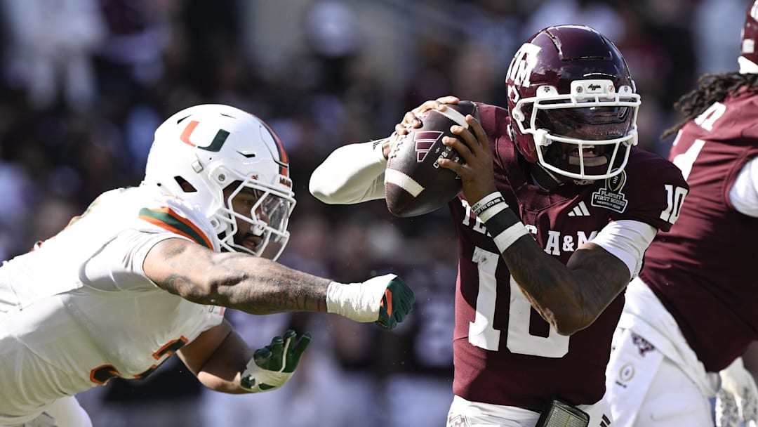 Texas A&M Aggies quarterback Marcel Reed scrambles against Miami Hurricanes defensive lineman Akheem Mesidor during the second half of the first round game of the CFP National Playoff at Kyle Field. Texas A&M Aggies quarterback Marcel Reed scrambles against Miami Hurricanes defensive lineman Akheem Mesidor during the second half of the first round game of the CFP National Playoff at Kyle Field.