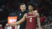 Dec 5, 2025; Houston, Texas, USA; Florida State Seminoles head coach Luke Loucks talks with guard Cam Miles (2) during the first half against the Houston Cougars at Toyota Center. Mandatory Credit: Troy Taormina-Imagn Images