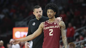 Dec 5, 2025; Houston, Texas, USA; Florida State Seminoles head coach Luke Loucks talks with guard Cam Miles (2) during the first half against the Houston Cougars at Toyota Center. Mandatory Credit: Troy Taormina-Imagn Images