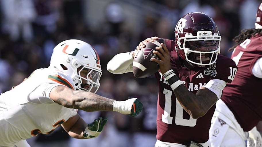Aggies quarterback Marcel Reed scrambles against Hurricanes defensive lineman Akheem Mesidor.