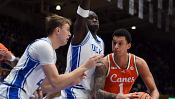 Jan 14, 2025; Durham, North Carolina, USA; Miami Hurricanes center Lynn Kidd (1) looks to shoot as Duke Blue Devils forward Cooper Flagg (2) and Duke Blue Devils center Khaman Maluach (9) defend during the first half at Cameron Indoor Stadium. Mandatory Credit: Rob Kinnan-Imagn Images