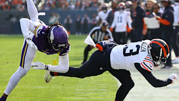 Nov 24, 2024; Chicago, Illinois, USA; Chicago Bears wide receiver Keenan Allen (13) makes a catch over Minnesota Vikings cornerback Shaquill Griffin (1) and after replay is ruled out of bounds on his left foot touching the line during the second quarter at Soldier Field. Mandatory Credit: Mike Dinovo-Imagn Images