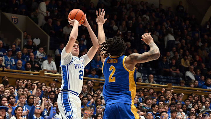 Jan 7, 2025; Durham, North Carolina, USA; Duke basketball forward Cooper Flagg (2) shoots over Pitt Panthers forward Cameron Corhen (2) during the second half at Cameron Indoor Stadium. 