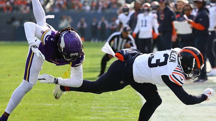 Nov 24, 2024; Chicago, Illinois, USA; Chicago Bears wide receiver Keenan Allen (13) makes a catch over Minnesota Vikings cornerback Shaquill Griffin (1) and after replay is ruled out of bounds on his left foot touching the line during the second quarter at Soldier Field. Mandatory Credit: Mike Dinovo-Imagn Images