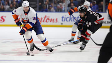 Nov 1, 2024; Buffalo, New York, USA;  New York Islanders defenseman Alexander Romanov (28) skates with the puck as Buffalo Sabres center Dylan Cozens (24) defends during the third period at KeyBank Center. Mandatory Credit: Timothy T. Ludwig-Imagn Images