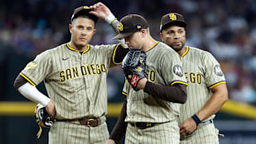 Jun 13, 2025; Phoenix, Arizona, USA; San Diego Padres third baseman Manny Machado (left), pitcher Stephen Kolek (center) and Xander Bogaerts react in the fifth inning against the Arizona Diamondbacks at Chase Field. Mandatory Credit: Mark J. Rebilas-Imagn Images