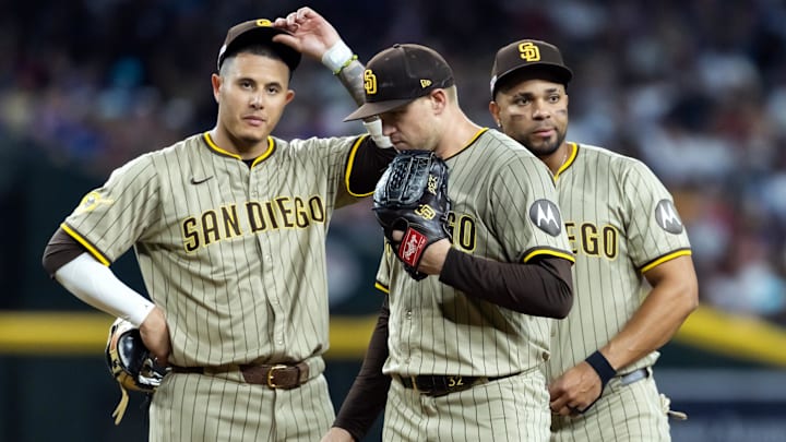 Jun 13, 2025; Phoenix, Arizona, USA; San Diego Padres third baseman Manny Machado (left), pitcher Stephen Kolek (center) and Xander Bogaerts react in the fifth inning against the Arizona Diamondbacks at Chase Field. Mandatory Credit: Mark J. Rebilas-Imagn Images