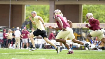 Apr 20, 2024; Tallahassee, Florida, USA; Florida State Seminoles head coach Mike Norvell races some of his players to the other end of the field during the Spring Showcase at Doak S. Campbell Stadium. Mandatory Credit: Melina Myers-USA TODAY Sports