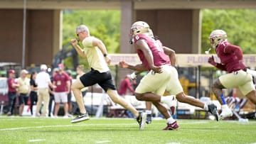Apr 20, 2024; Tallahassee, Florida, USA; Florida State Seminoles head coach Mike Norvell races some of his players to the other end of the field during the Spring Showcase at Doak S. Campbell Stadium. Mandatory Credit: Melina Myers-USA TODAY Sports