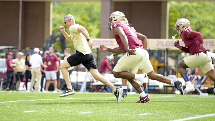 Apr 20, 2024; Tallahassee, Florida, USA; Florida State Seminoles head coach Mike Norvell races some of his players to the other end of the field during the Spring Showcase at Doak S. Campbell Stadium. Mandatory Credit: Melina Myers-USA TODAY Sports