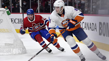 Nov 4, 2021; Montreal, Quebec, CAN; New York Islanders defenseman Noah Dobson (8) plays the puck and Montreal Canadiens forward Adam Brooks (24) gives chase during the first period at the Bell Centre. Mandatory Credit: Eric Bolte-Imagn Images