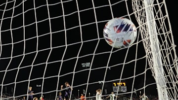 Dec 12, 2025; Cary, NC, USA; Washington Huskies midfielder Zach Ramsey (6) scores a goal as Furman Paladins goalkeeper Ivan Horvat (30) defends in the first half at First Horizon Stadium. Mandatory Credit: Bob Donnan-Imagn Images