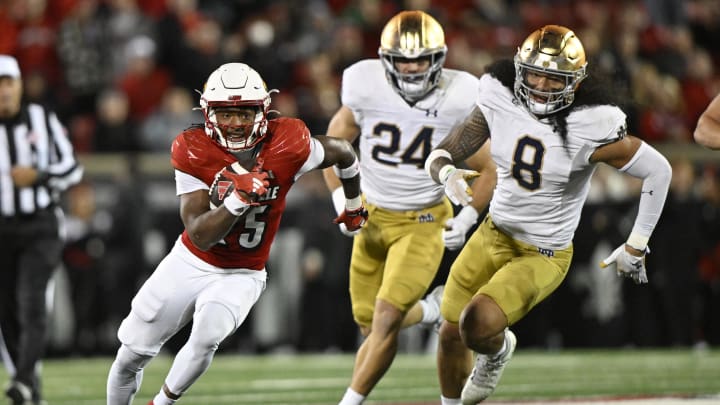 Oct 7, 2023; Louisville, Kentucky, USA; Louisville Cardinals running back Jawhar Jordan (25) runs the ball against Notre Dame Fighting Irish linebacker Marist Liufau (8) and  linebacker Jack Kiser (24) during the second half at L&N Federal Credit Union Stadium.