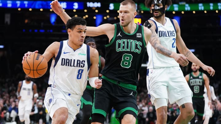 Mar 1, 2024; Boston, Massachusetts, USA; Dallas Mavericks guard Josh Green (8) drives the ball against Boston Celtics center Kristaps Porzingis (8) in the first quarter at TD Garden. Mandatory Credit: David Butler II-USA TODAY Sports