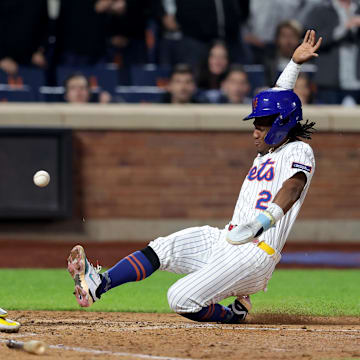 May 12, 2025; New York City, New York, USA; New York Mets second baseman Luisangel Acuna (2) scores ahead of the tag by Pittsburgh Pirates catcher Henry Davis (32) on a single by Mets first baseman Pete Alonso (not pictured) during the seventh inning at Citi Field. Mandatory Credit: Brad Penner-Imagn Images
