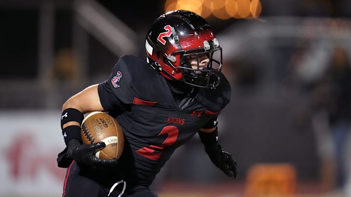 Liberty Lions kick returner Owen Dalton (2) runs with the ball against the Higley Knights during their Open Division state football playoff game at Liberty High School football stadium in Peoria on Nov. 22, 2024.
