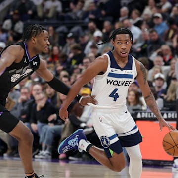 Jan 30, 2025; Salt Lake City, Utah, USA; Minnesota Timberwolves guard Rob Dillingham (4) runs past Utah Jazz guard Isaiah Collier (13) during the second half at Delta Center. Mandatory Credit: Chris Nicoll-Imagn Images