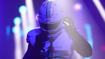 Miami Dolphins player adjusting his helmet