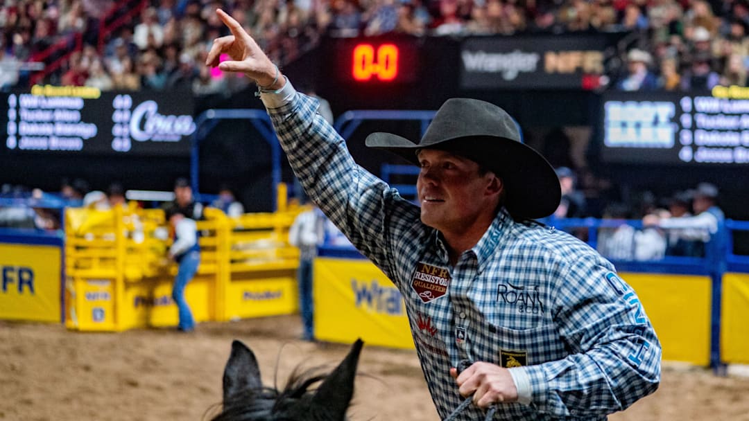 Tucker Allen taking his victory lap after splitting round four with Will Lummus at the NFR 