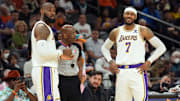 Mar 13, 2022; Phoenix, Arizona, USA; Los Angeles Lakers forward LeBron James (6) and forward Carmelo Anthony (7) argue a call with an official during the first half of the game against the Phoenix Suns at Footprint Center. Mandatory Credit: Joe Camporeale-Imagn Images