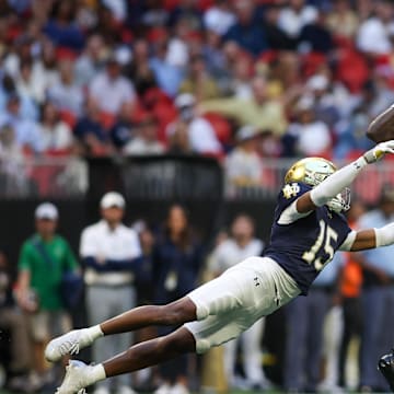 Oct 19, 2024; Atlanta, Georgia, USA; Georgia Tech Yellow Jackets wide receiver Abdul Janneh Jr. (4) catches a ball past Notre Dame Fighting Irish cornerback Leonard Moore (15) in the third quarter at Mercedes-Benz Stadium. Mandatory Credit: Brett Davis-Imagn Images
