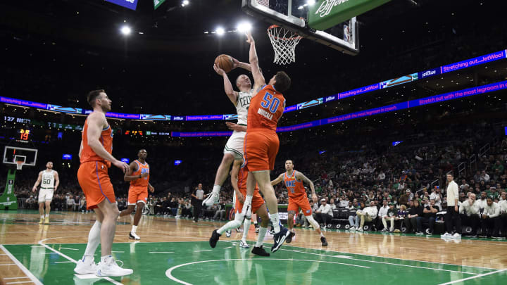 Apr 3, 2024; Boston, Massachusetts, USA; Boston Celtics guard Payton Pritchard (11) controls the ball while Oklahoma City Thunder center Mike Muscala (50) defends during the second half at TD Garden. 