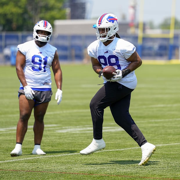 defensive tackle T.J. Sanders (98) makes a catch with defensive tackle Ed Oliver (91) looking on