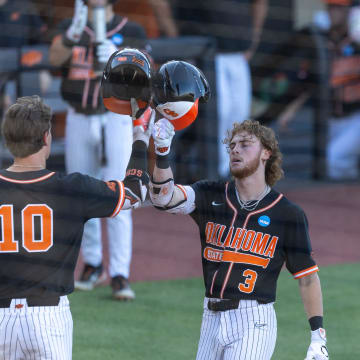 Jun 1, 2024; Stillwater, OK, USA; Oklahoma State utility Carson Benge (3) celebrates with outfielder Nolan Schubart (10) after making it home during a NCAA regional baseball game against Florida at O'Brate Stadium. Mandatory Credit: Mitch Alcala-The Oklahoman