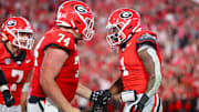 Georgia Bulldogs running back Trevor Etienne (1) celebrates with offensive lineman Drew Bobo after a touchdown.