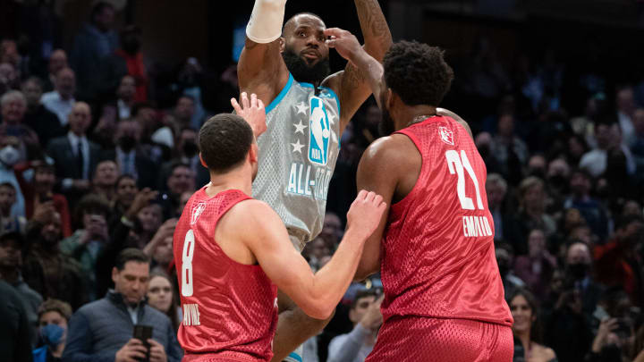 February 20, 2022; Cleveland, Ohio, USA; Team LeBron forward LeBron James of the Los Angeles Lakers (6) shoots the basketball against Team Durant guard/forward Zach Lavine of the Chicago Bulls (8) and Team Durant center Joel Embiid of the Philadelphia 76ers (21) during the fourth quarter in the 2022 NBA All-Star Game at Rocket Mortgage FieldHouse. Mandatory Credit: Kyle Terada-USA TODAY Sports