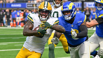 Oct 6, 2024; Inglewood, California, USA; Green Bay Packers running back Josh Jacobs (8) sprints to the end zone past Los Angeles Rams linebacker Jared Verse (8) to score a touchdown in the first quarter at SoFi Stadium. Mandatory Credit: Robert Hanashiro-Imagn Images