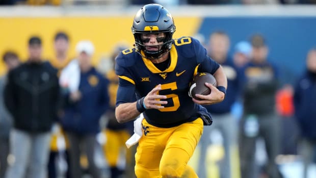 West Virginia Mountaineers quarterback Garrett Greene on a rushing attempt during a college football game in the Big 12.