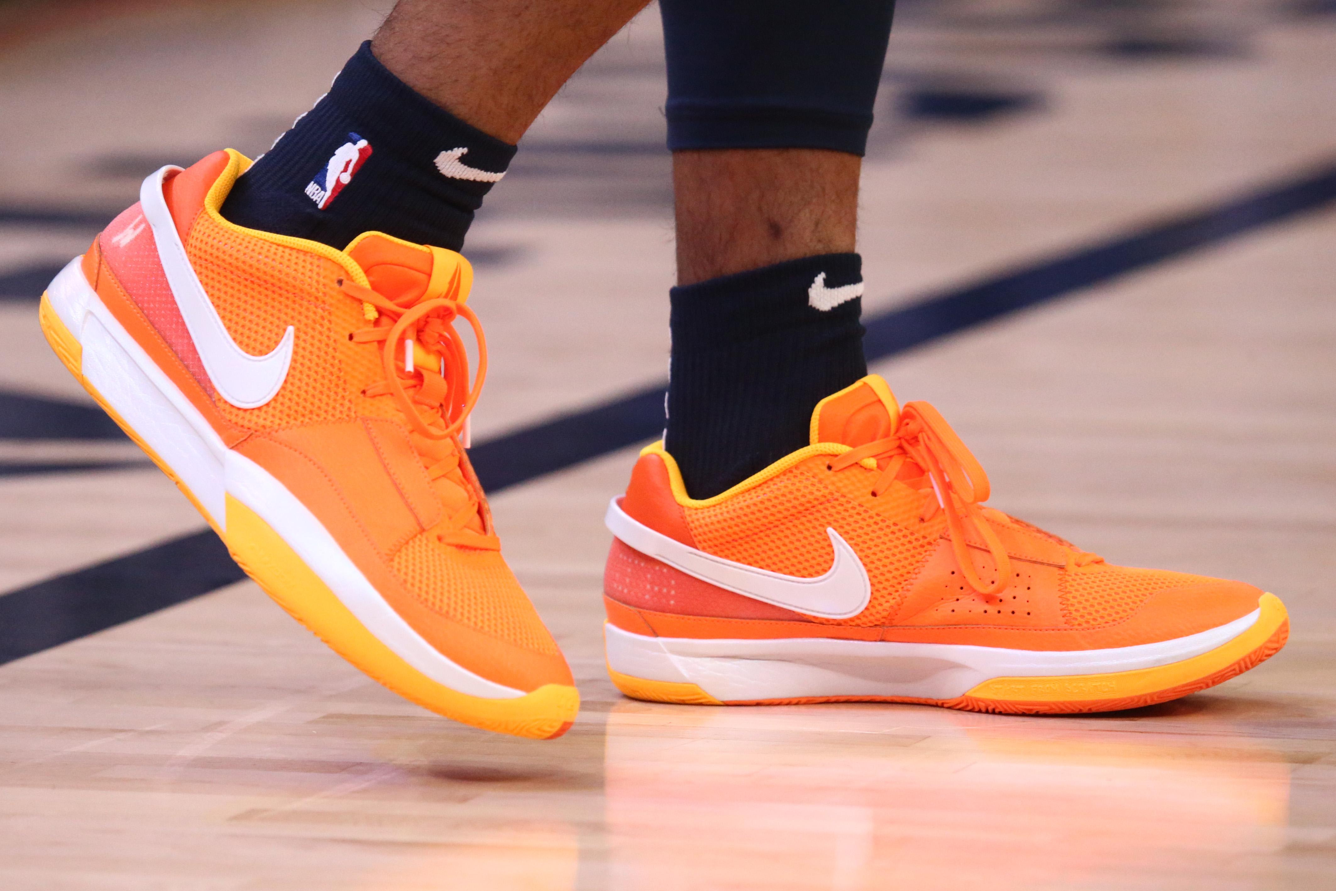 Side view of Ja Morant's orange and white Nike sneakers.