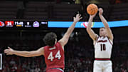 Nov 26, 2025; Louisville, Kentucky, USA;  Louisville Cardinals guard Isaac McKneely (10) shoots against NJIT Highlanders guard Rocco Awad (44) during the first half at KFC Yum! Center. Mandatory Credit: Jamie Rhodes-Imagn Images