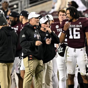 Nov 11, 2023; College Station, Texas, USA; Texas A&M Aggies quarterback Jaylen Henderson (16) speaks with head coach Jimbo Fisher during the second half against the Mississippi State Bulldogs at Kyle Field. Mandatory Credit: Maria Lysaker-USA TODAY Sports