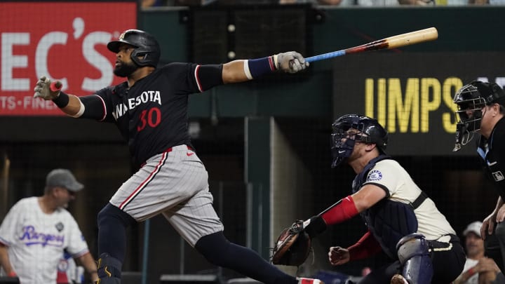 Minnesota Twins first baseman Carlos Santana (30) follows through on a three-run home run during the fifth inning against the Texas Rangers at Globe Life Field in Arlington, Texas, on Aug. 16, 2024.