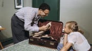 Girl Watching Her Father Pack