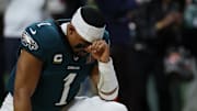 Feb 9, 2025; New Orleans, LA, USA; Philadelphia Eagles quarterback Jalen Hurts (1) kneels in the end zone prior to Super Bowl LIX  against the Kansas City Chiefs at Caesars Superdome. 