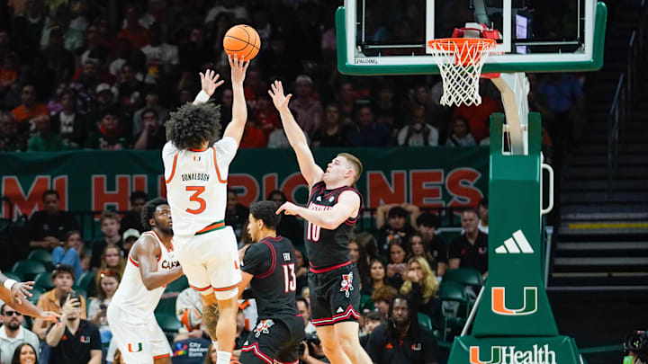 Mar 7, 2026; Coral Gables, Florida, USA; Miami Hurricanes guard Tre Donaldson (3) shoots the ball against Louisville Cardinals guard Isaac McKneely (10) at Watsco Center. Mandatory Credit: Jeff Romance-Imagn Images