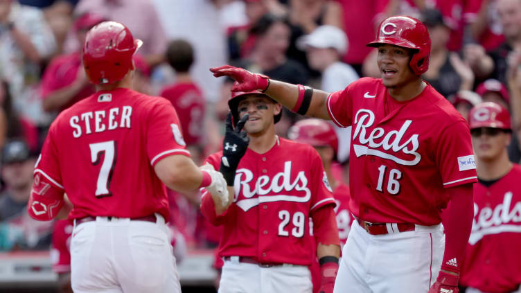 Cincinnati Reds players Spencer Steer, TJ Friedl, and Noelvi Marte