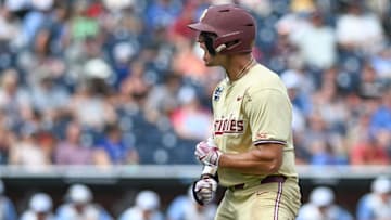 Jun 18, 2024; Omaha, NE, USA;  Florida State Seminoles center fielder Max Williams (18) reacts after hitting a home run against the North Carolina Tar Heels during the ninth inning at Charles Schwab Field Omaha. Mandatory Credit: Steven Branscombe-Imagn Images