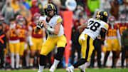 Nov 15, 2025; Los Angeles, California, USA; Iowa Hawkeyes quarterback Mark Gronowski (11) drops back to pass against the Southern California Trojans during the first half at the Los Angeles Memorial Coliseum. Mandatory Credit: Gary A. Vasquez-Imagn Images