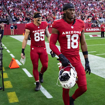 Jan 5, 2025; Glendale, Arizona, USA; Arizona Cardinals wide receiver Marvin Harrison Jr. (18) and tight end Trey McBride (85) with quarterback Kyler Murray (1) against the San Francisco 49ers at State Farm Stadium. Mandatory Credit: Mark J. Rebilas-Imagn Images
